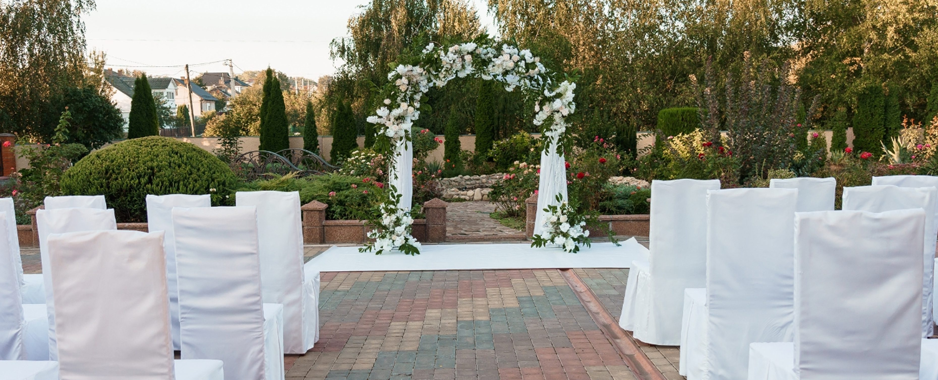 Garden ceremony setup with decorated arch